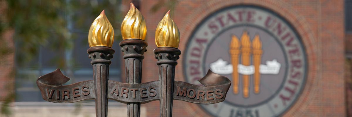 Vires Artes Mores Torches & University Seal